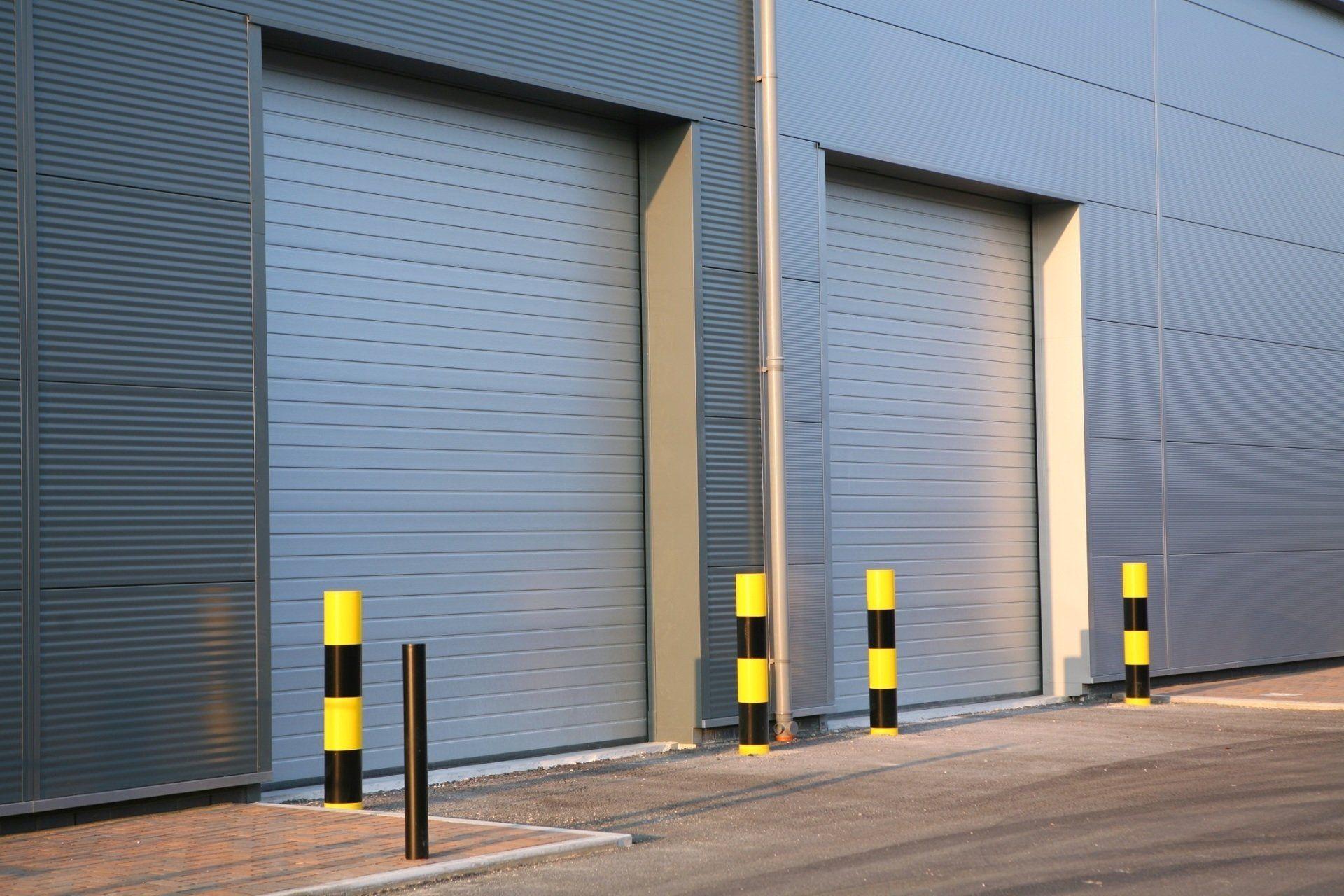 Two commercial; roll-up doors for loading dock