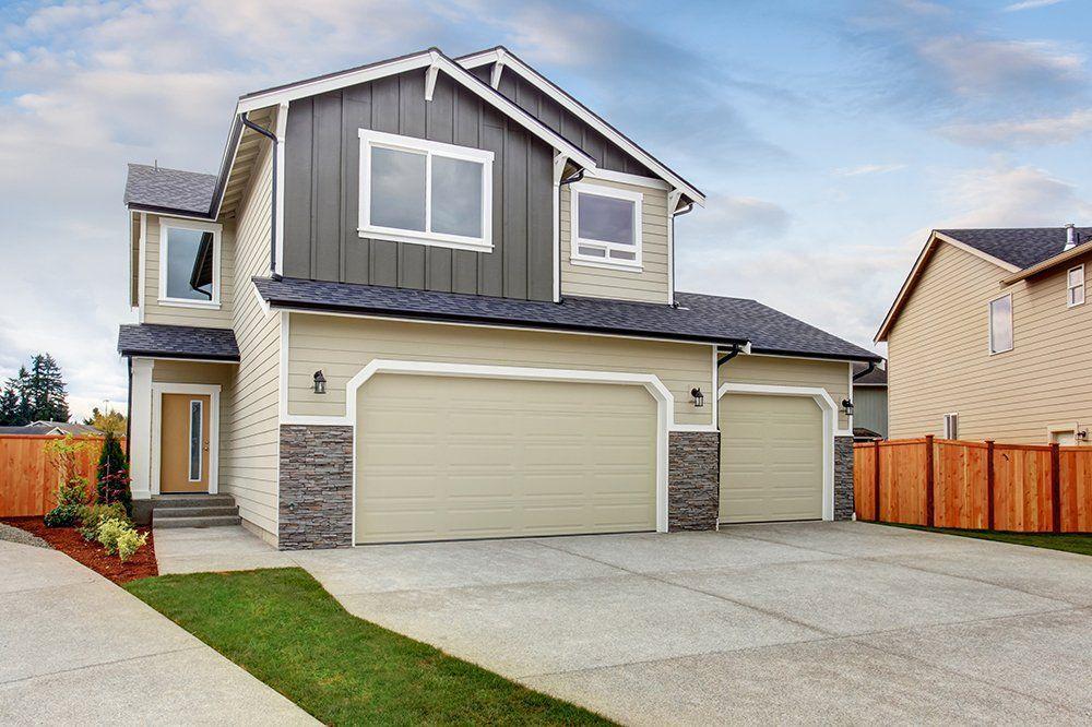 Looking at a house from the street With 2 garage doors